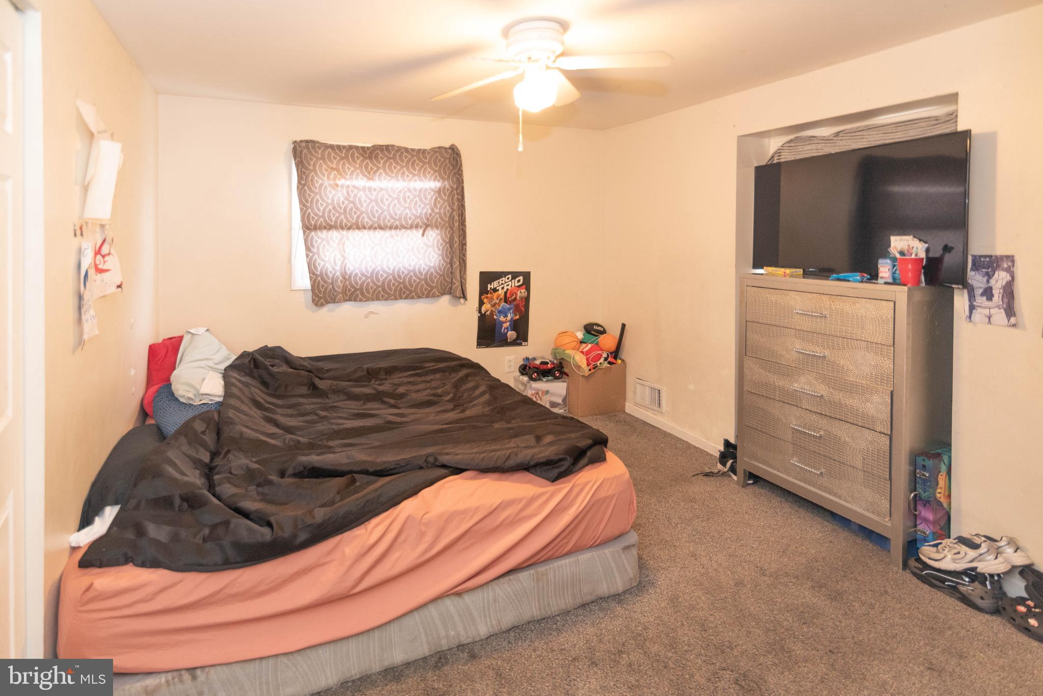 5686 Utrecht Road Baltimore, MD 21206 - Photo 13 of 35 a bed room with a bed and a mirror