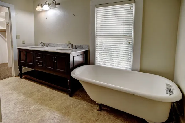 a bathroom with a bathtub and a sink