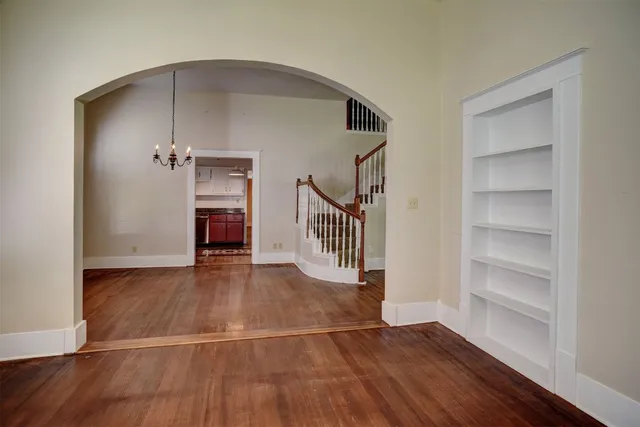 a view of a hallway with wooden floor and entryway