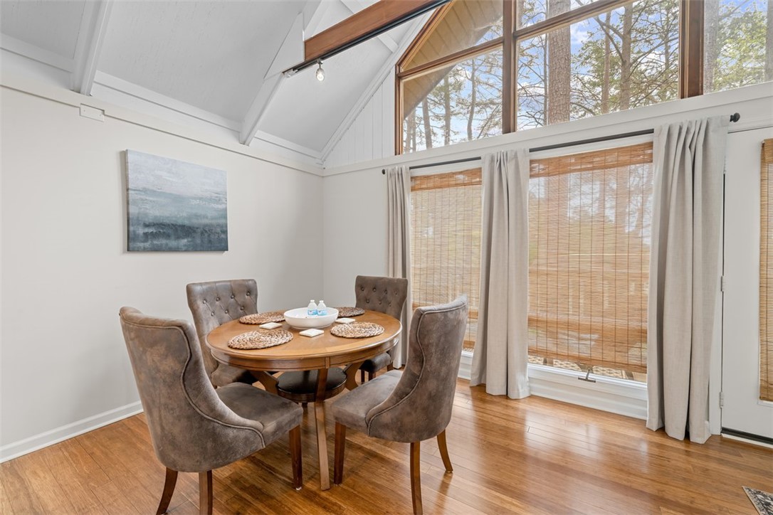 560 South Flagship Drive, Unit 6 Salem, SC 29676 - Photo 5 of 14 This bright dining area features vaulted ceilings and large windows, creating an inviting space for gatherings.