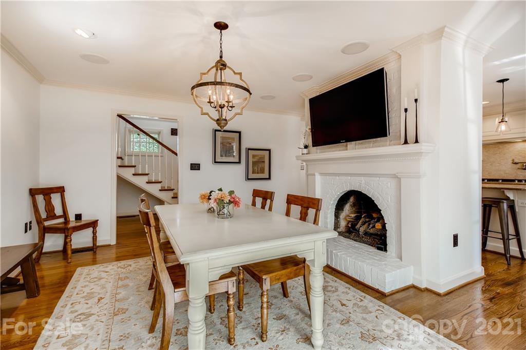 3929 Glenfall Avenue Charlotte, NC 28210 - Photo 11 of 30 a view of a dining room with furniture wooden floor and a chandelier