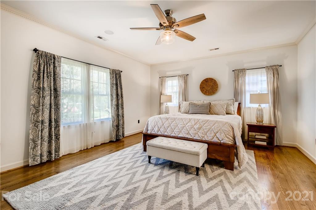 3929 Glenfall Avenue Charlotte, NC 28210 - Photo 16 of 30 a bedroom with a bed lamp and a large window with wooden floor