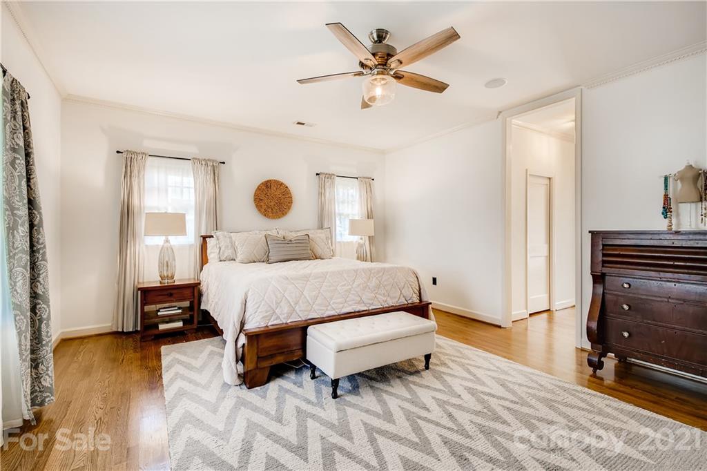 3929 Glenfall Avenue Charlotte, NC 28210 - Photo 17 of 30 a bedroom with a bed and wooden floor