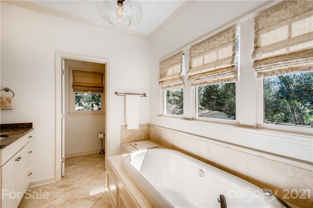 3929 Glenfall Avenue Charlotte, NC 28210 - Photo 19 of 30 a spacious bathroom with a tub and a large window
