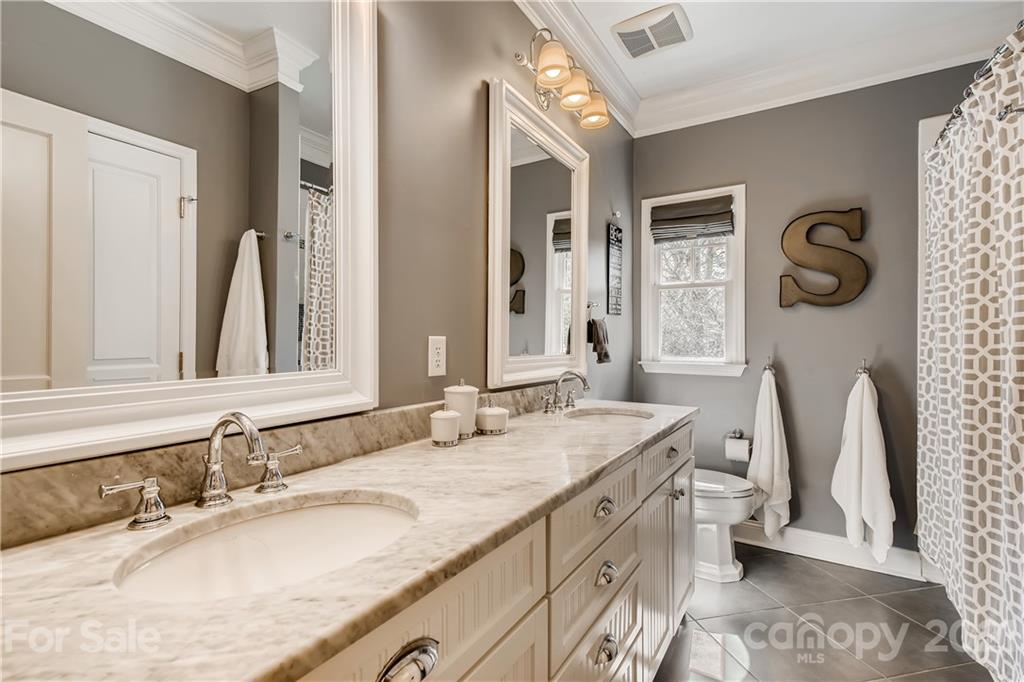 3929 Glenfall Avenue Charlotte, NC 28210 - Photo 23 of 30 a bathroom with a granite countertop sink and a mirror
