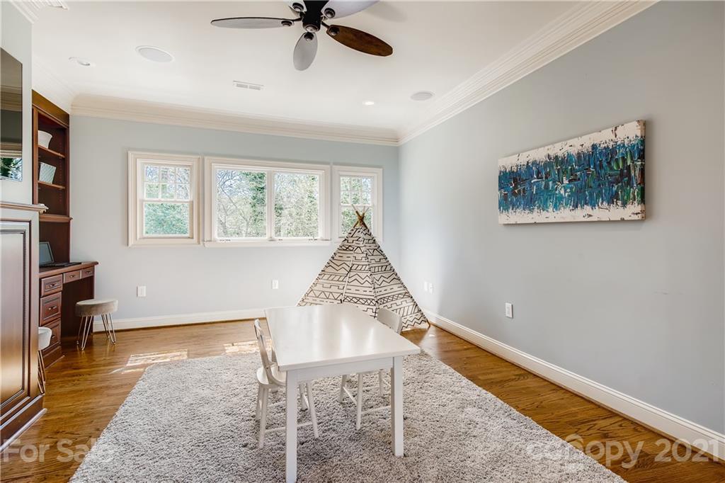 3929 Glenfall Avenue Charlotte, NC 28210 - Photo 26 of 30 a view of an empty room with a window and wooden floor