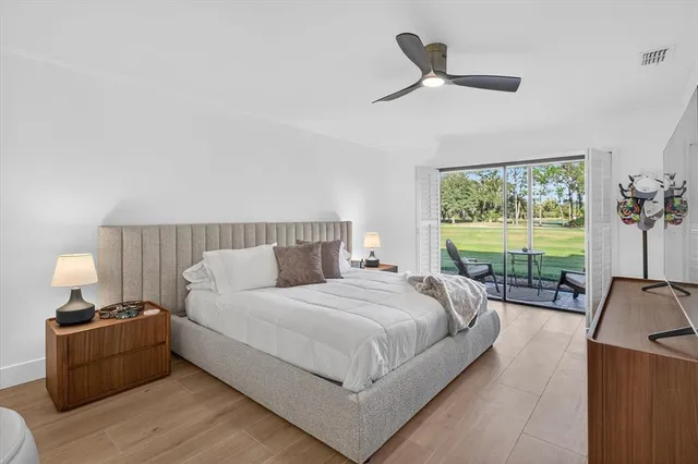 a bedroom with a bed and a large window