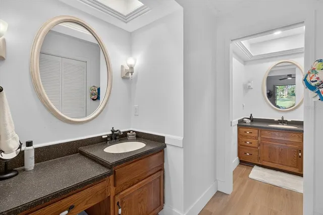 a bathroom with a granite countertop sink mirror and vanity