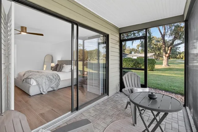 a view of a chairs and table in patio with a yard