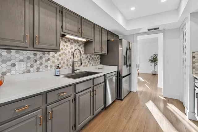 a kitchen with stainless steel appliances a stove a sink and a microwave