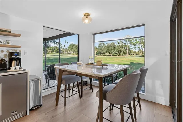a view of a dining room with furniture window and outside view