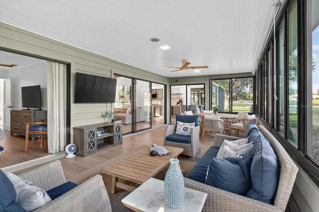 a bedroom with a bed a large window with table and chairs