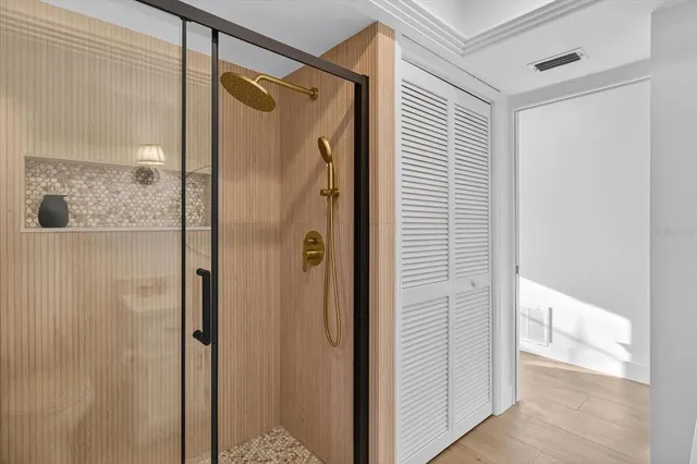 a bedroom with a bed wooden floor and a window