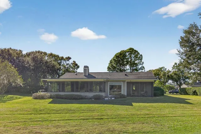 an aerial view of green landscape with trees houses and mountain view