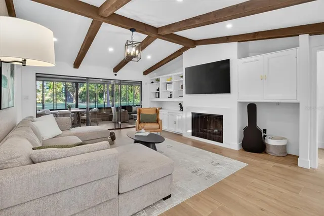 a living room with furniture a fireplace and a flat screen tv