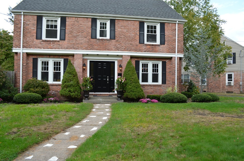 425 Trafton Road Springfield, MA 01108 - Photo 4 of 28 a view of a brick house with a yard plants and large tree