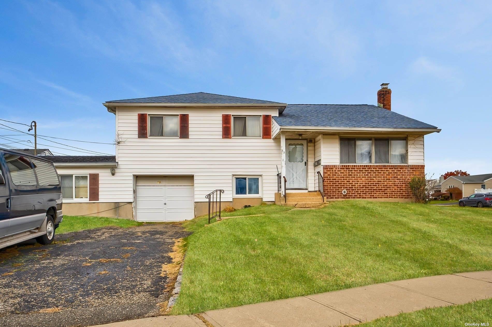 73 Froehlich Farm Road Hicksville, NY 11801 - Photo 1 of 1 a front view of a house with a garden and yard
