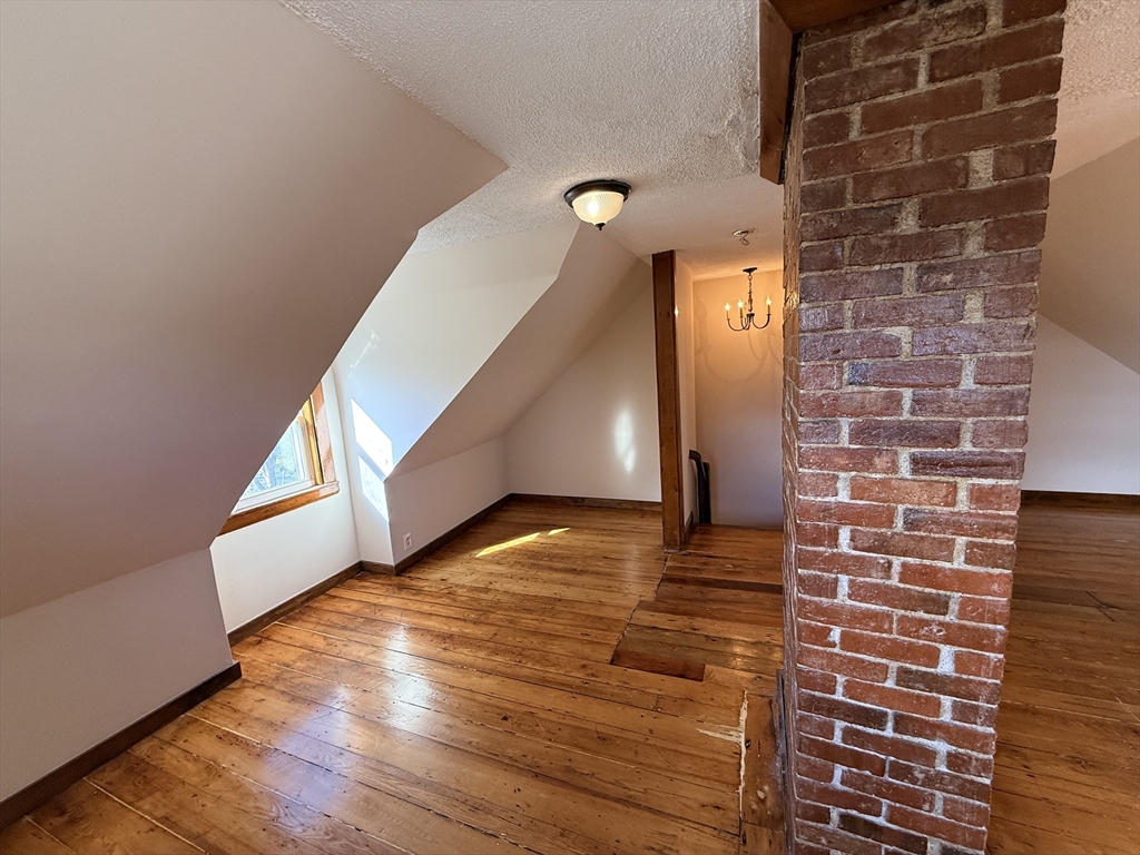 5 Oakland Street, Unit 1 Boston, MA 02119 - Photo 19 of 25 a view of a hallway with wooden floor