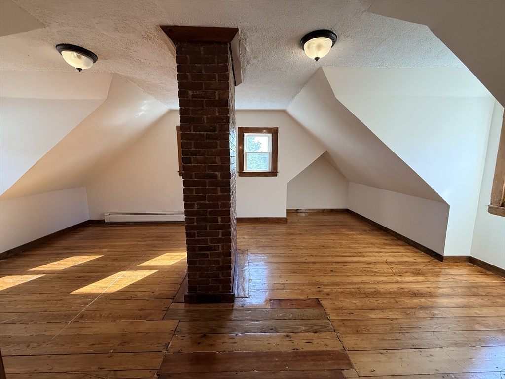 5 Oakland Street, Unit 1 Boston, MA 02119 - Photo 20 of 25 a view of a room has wooden floor and stairs