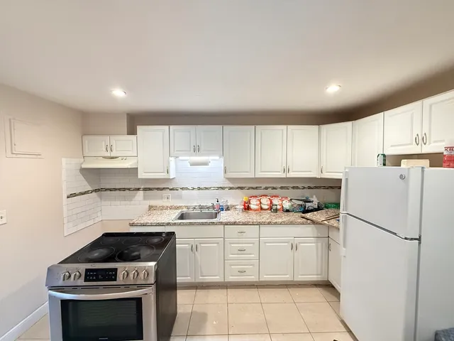 a kitchen with a stove sink and refrigerator