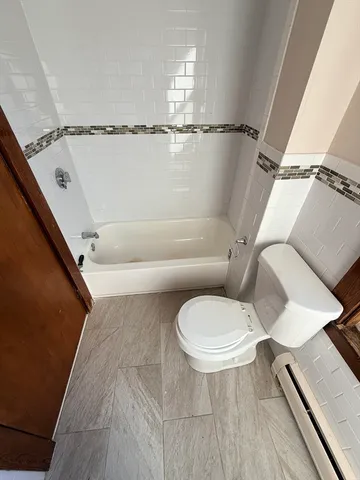 a bathroom with a toilet and a bathtub