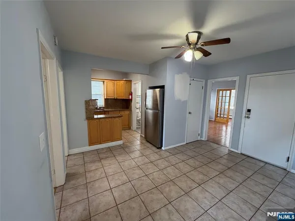 a view of a kitchen an empty room and window