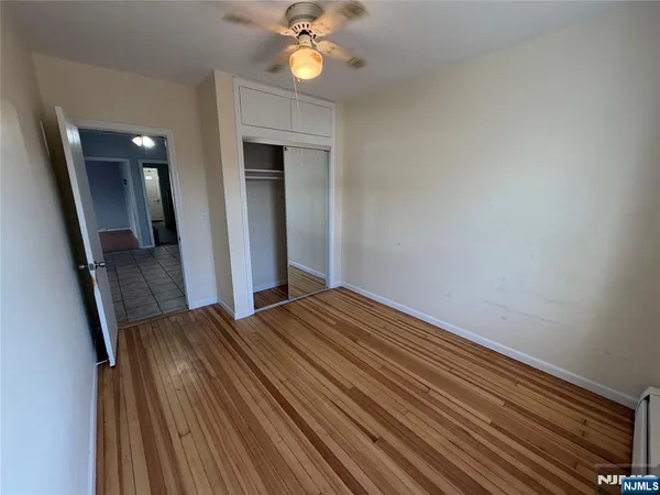 a view of a livingroom with wooden floor and staircase