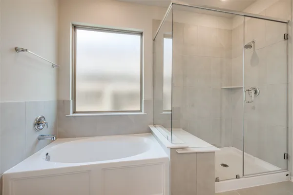 a bathroom with a tub sink and mirror