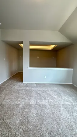 a view of a hallway with wooden floor and stairs