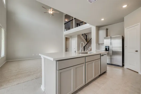 a kitchen with stainless steel appliances white cabinets and a refrigerator