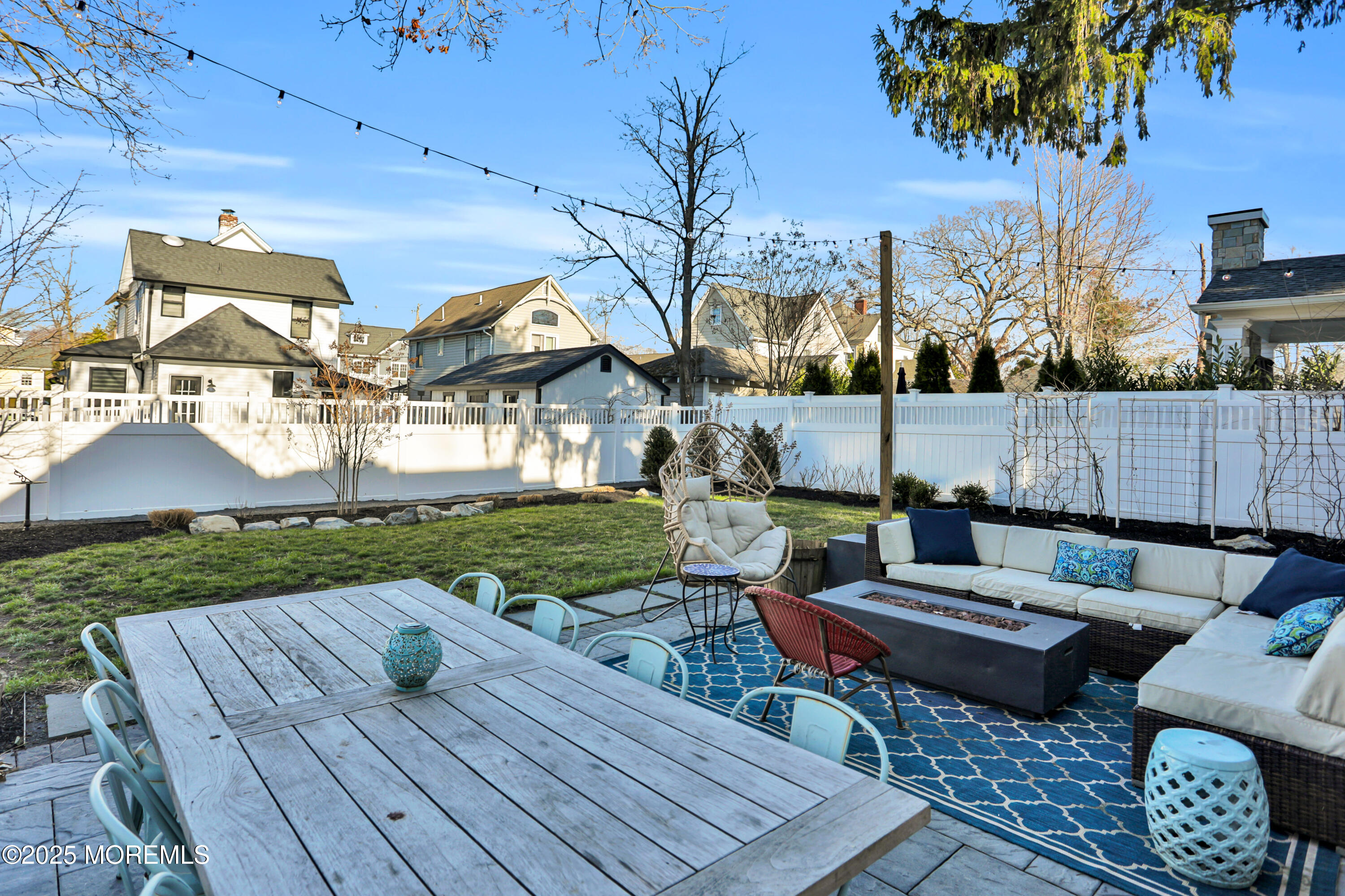 7 Allen Street Rumson, NJ 07760 - Photo 41 of 45 a view of a patio with couches chairs and a fire pit with wooden fence