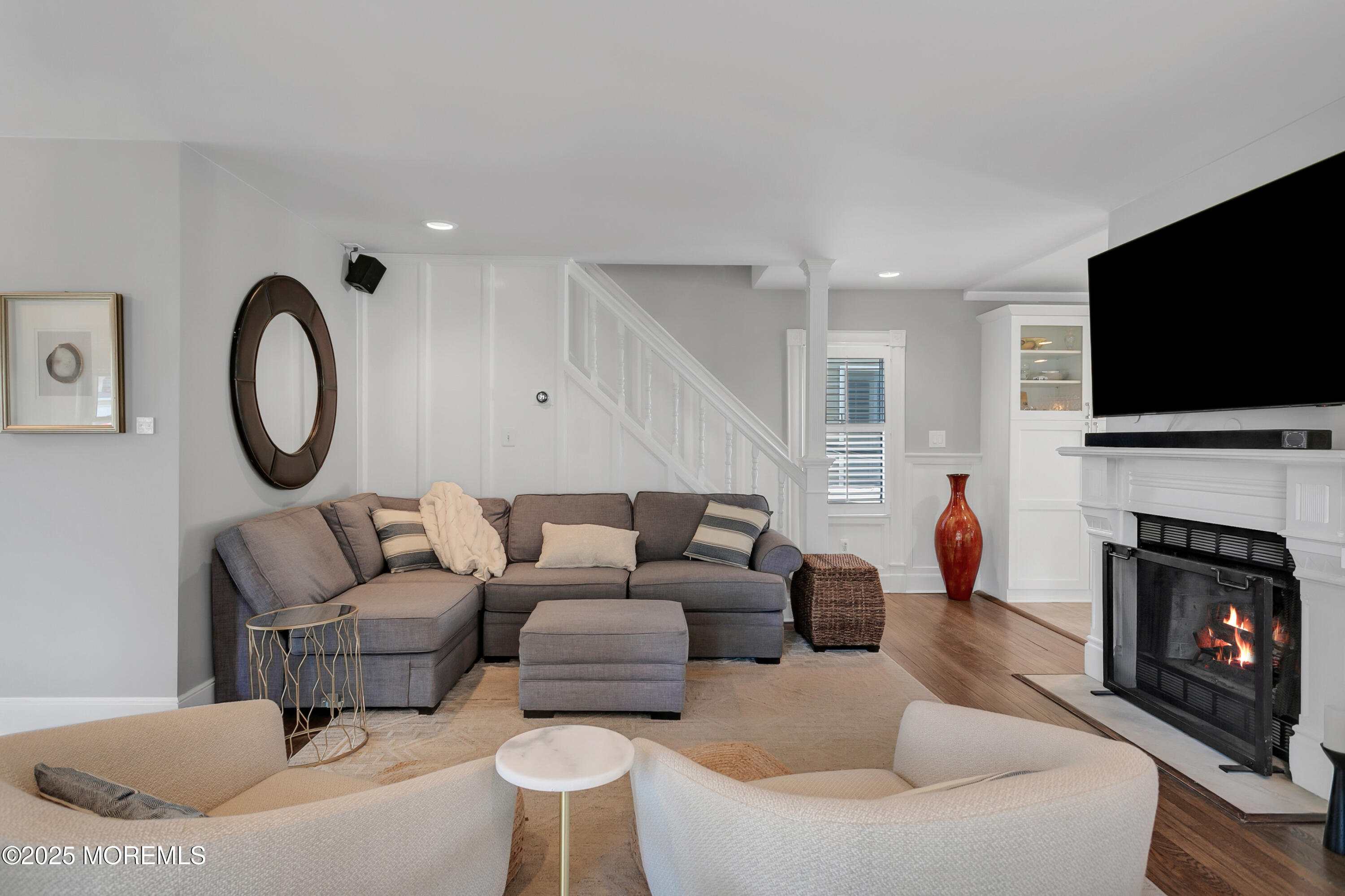 7 Allen Street Rumson, NJ 07760 - Photo 8 of 45 a living room with furniture a fireplace and a flat screen tv