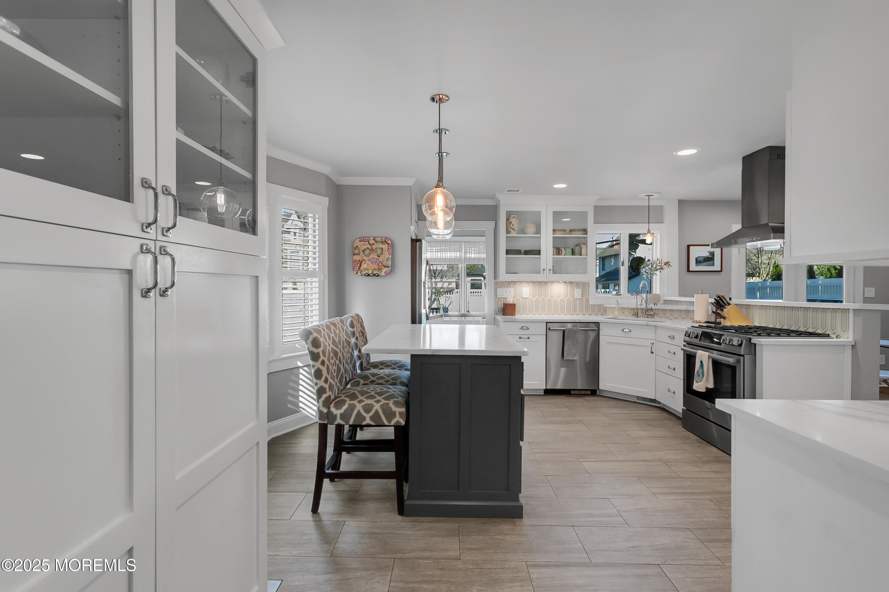 7 Allen Street Rumson, NJ 07760 - Photo 10 of 45 a kitchen with stainless steel appliances kitchen island granite countertop a table chairs and a refrigerator