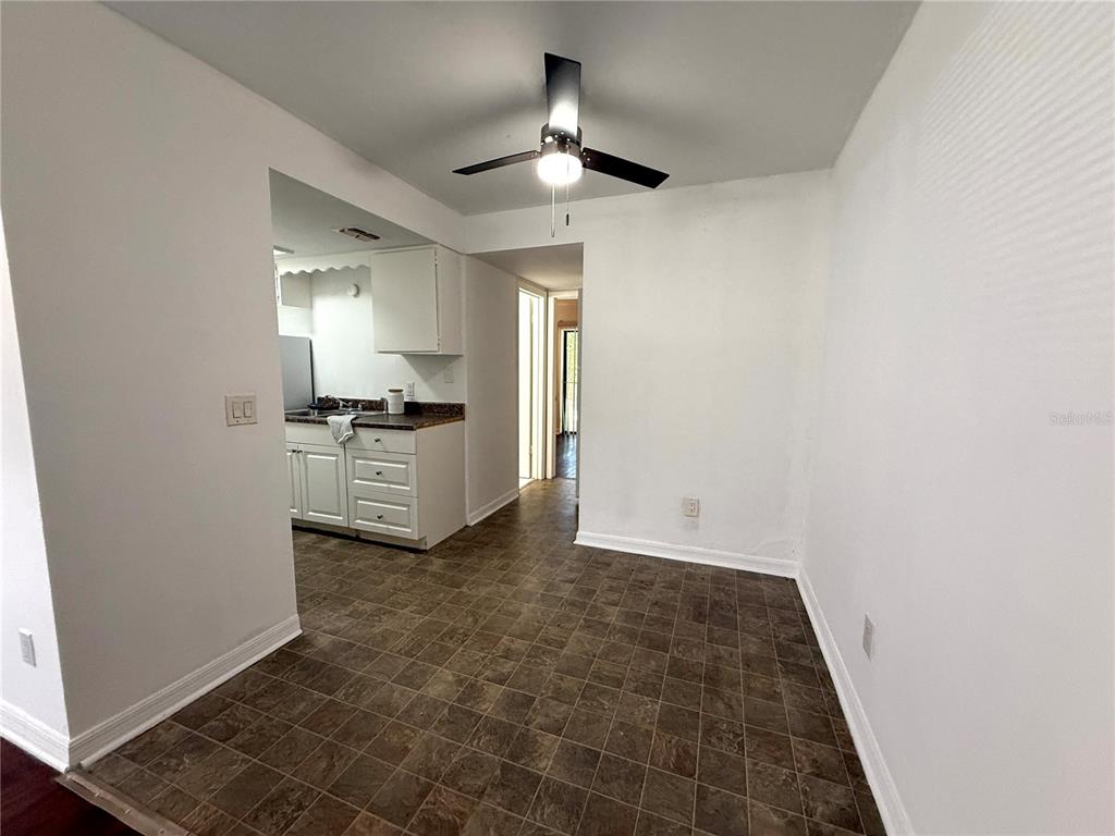 510 Southwest 69th Street, Unit A Gainesville, FL 32607 - Photo 3 of 9 a view of a kitchen with a sink and a refrigerator
