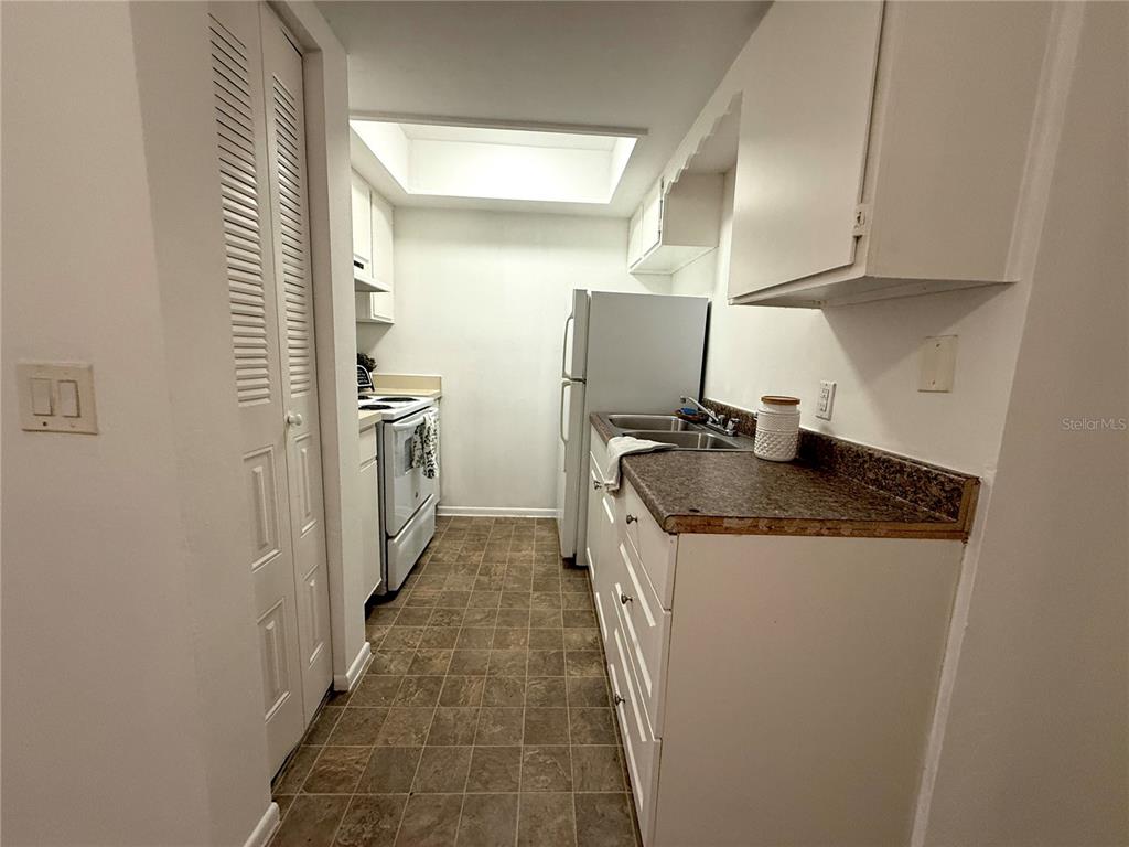 510 Southwest 69th Street, Unit A Gainesville, FL 32607 - Photo 4 of 9 a kitchen with a sink a refrigerator and washer