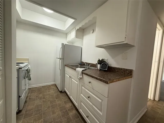 a kitchen with appliances cabinets and a sink