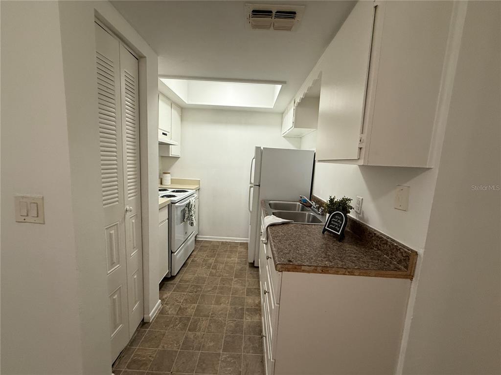 510 Southwest 69th Street, Unit A Gainesville, FL 32607 - Photo 7 of 9 a kitchen with sink refrigerator and cabinets