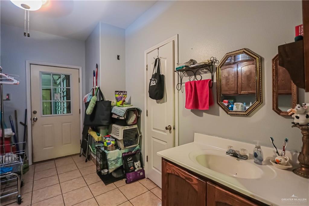 4701 Russell Circle Mission, TX 78574 - Photo 16 of 41 a bathroom with a sink mirror and cabinets