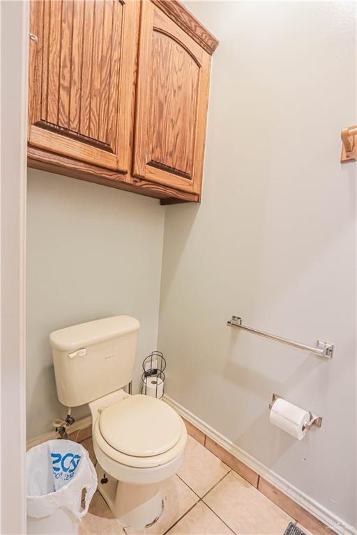 4701 Russell Circle Mission, TX 78574 - Photo 17 of 41 a white toilet sitting next to a bathroom sink and vanity
