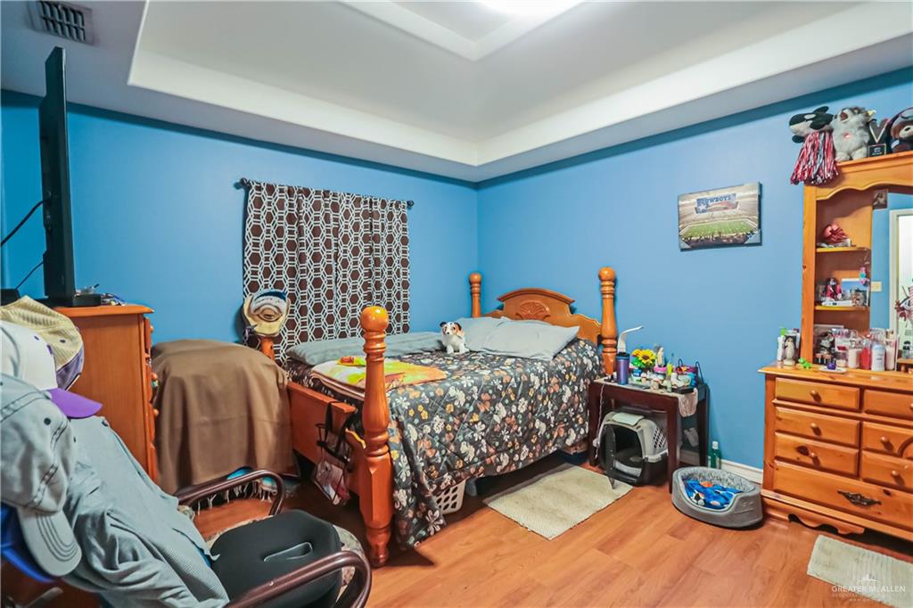 4701 Russell Circle Mission, TX 78574 - Photo 20 of 41 Bedroom with wood finished floors and a raised ceiling