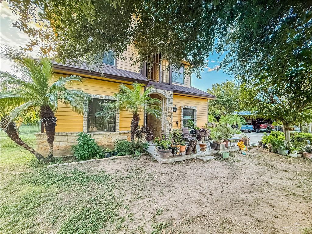 4701 Russell Circle Mission, TX 78574 - Photo 5 of 41 Rear view of property featuring a patio and stone siding