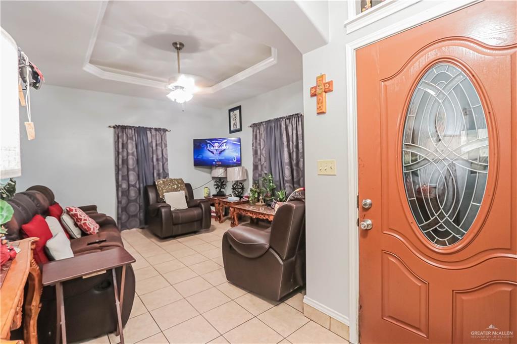 4701 Russell Circle Mission, TX 78574 - Photo 10 of 41 Entrance foyer featuring a tray ceiling, light tile patterned floors, and a ceiling fan