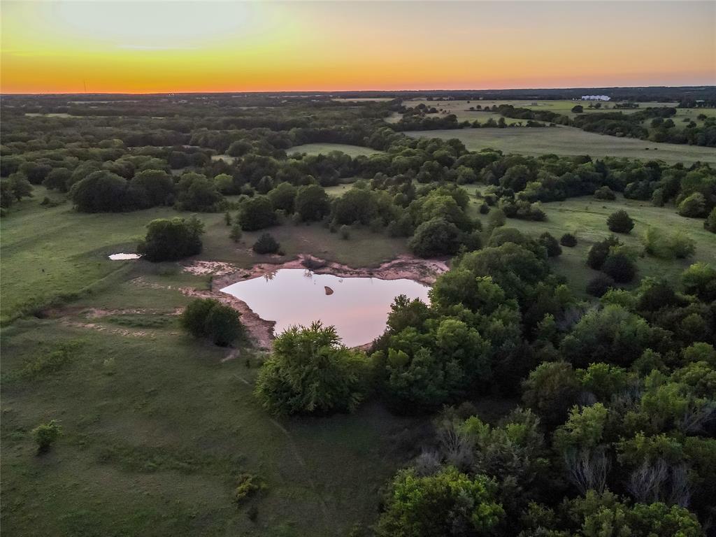 5444 Well Service Road Bowie, TX 76230 - Photo 11 of 38 an aerial view of residential houses with outdoor space and trees