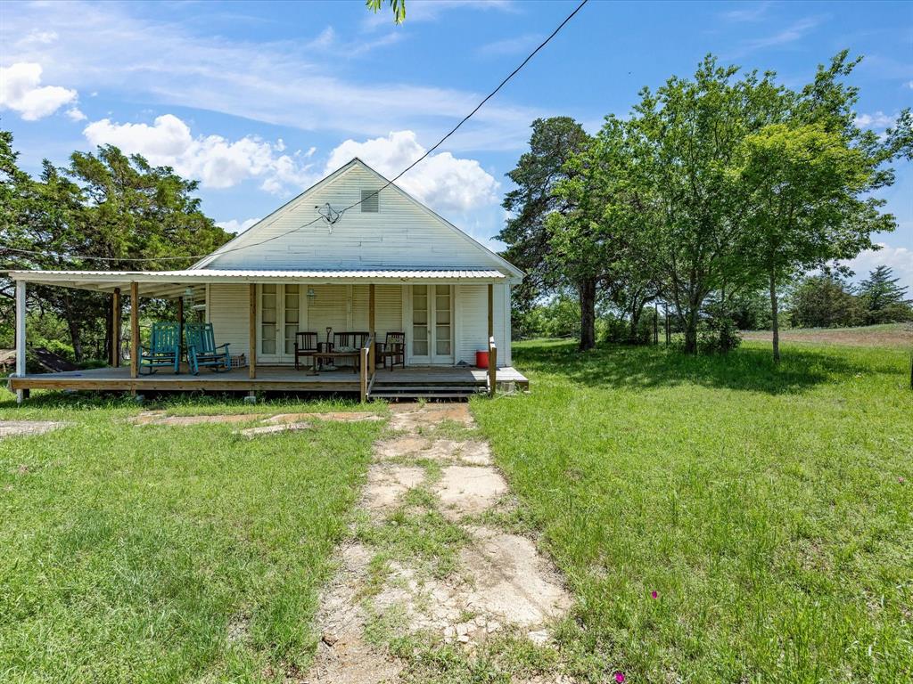 5444 Well Service Road Bowie, TX 76230 - Photo 15 of 38 a view of a house with a yard