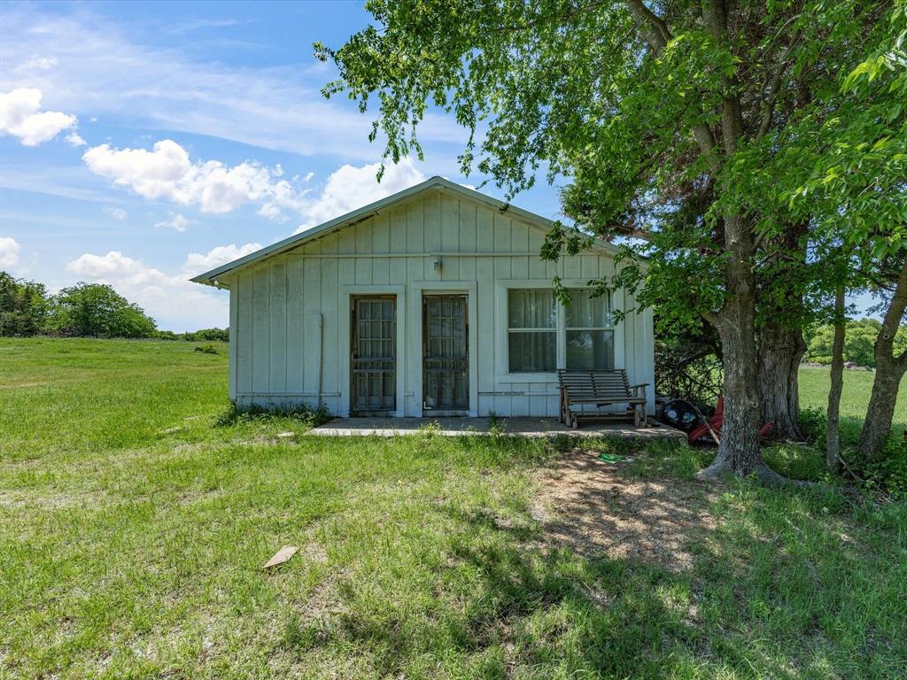 5444 Well Service Road Bowie, TX 76230 - Photo 19 of 38 a view of a house with a yard