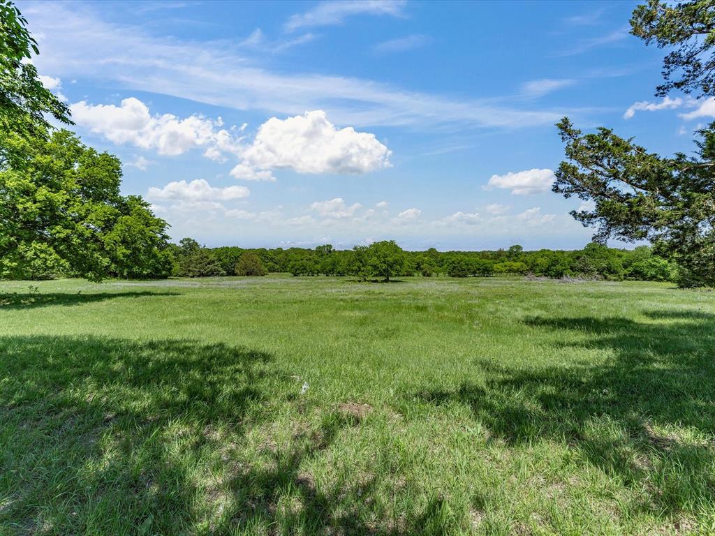 5444 Well Service Road Bowie, TX 76230 - Photo 20 of 38 a view of a lake with a big yard