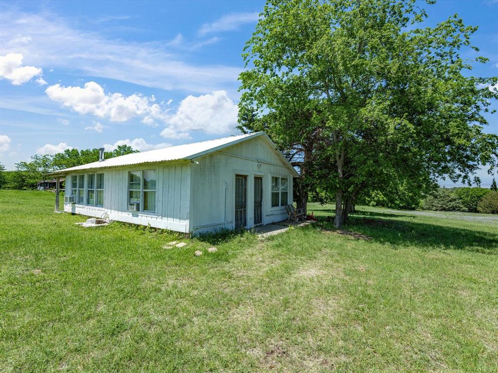 5444 Well Service Road Bowie, TX 76230 - Photo 22 of 38 a view of a house with a yard