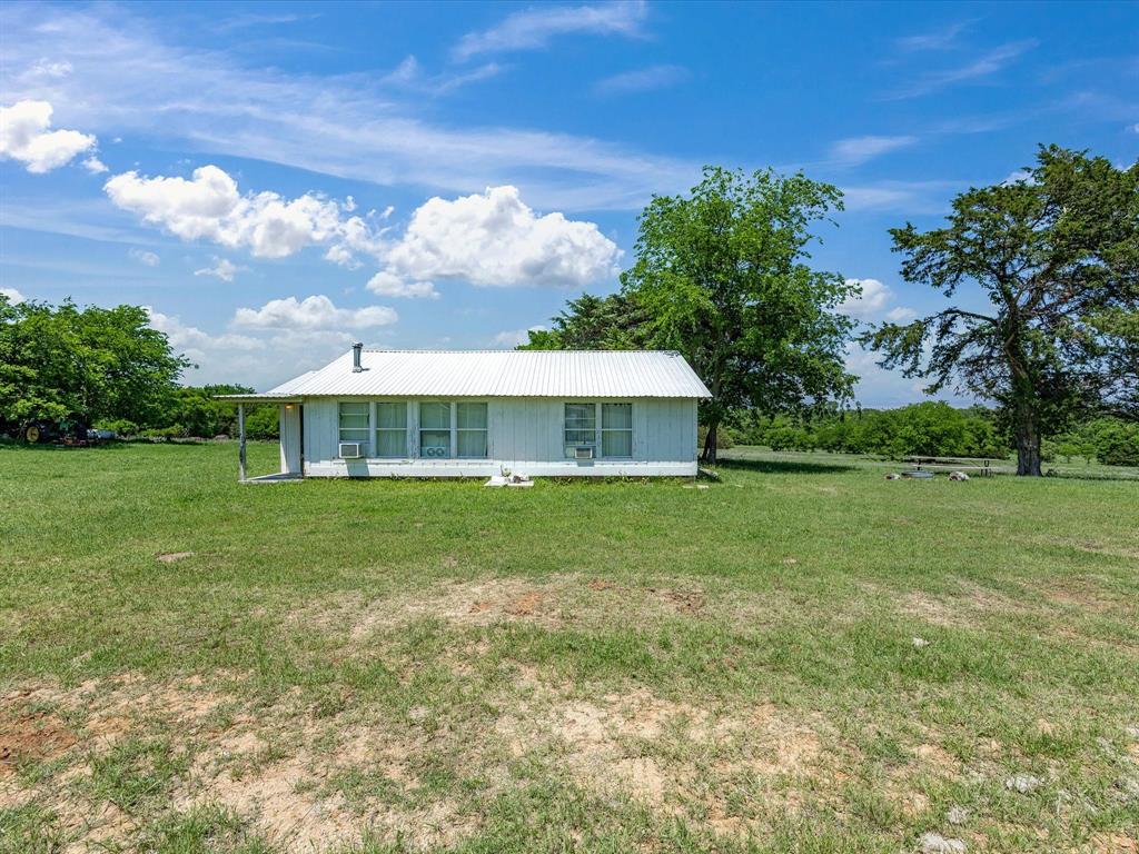 5444 Well Service Road Bowie, TX 76230 - Photo 23 of 38 a front view of a house with garden
