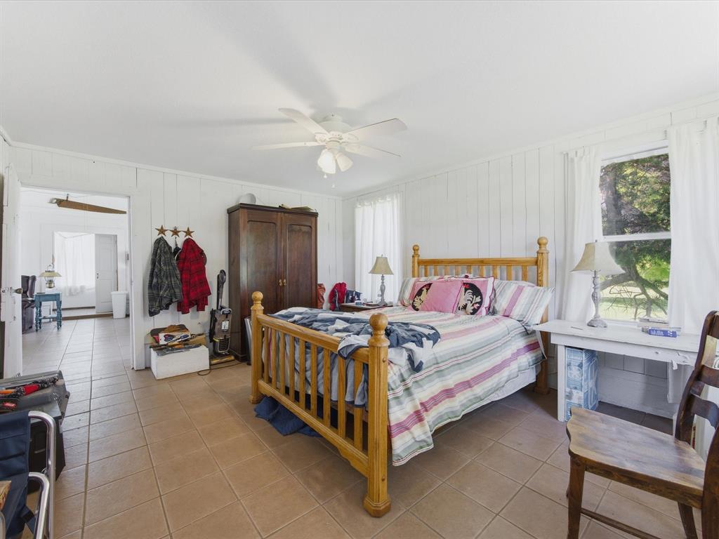 5444 Well Service Road Bowie, TX 76230 - Photo 25 of 38 a bedroom with a bed and a window