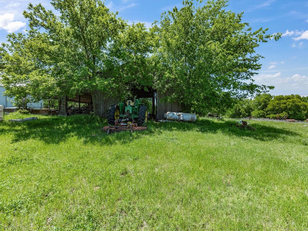 5444 Well Service Road Bowie, TX 76230 - Photo 27 of 38 a view of backyard with outdoor seating and green space